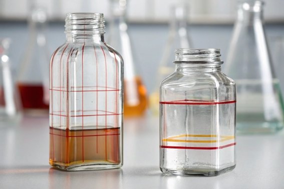 Clear glass sample bottles with red level marks for volume measurement and lab testing
