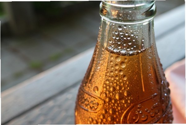 Amber glass bottle neck with condensation droplets in close up