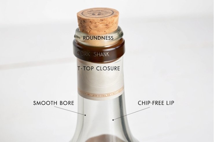 Close up of spirits bottle neck showing cork shank t top closure and smooth chip free lip