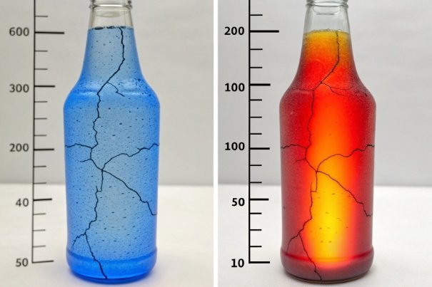 Cracked glass bottles with blue and red liquid showing thermal shock damage comparison