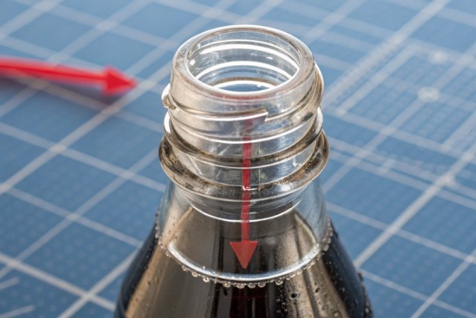 Glass bottle neck inspection with arrows marking finish defects for quality control