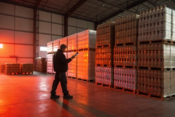 Pallet inventory check Warehouse worker scanning palletized bottles for inventory and bulk shipment quality control