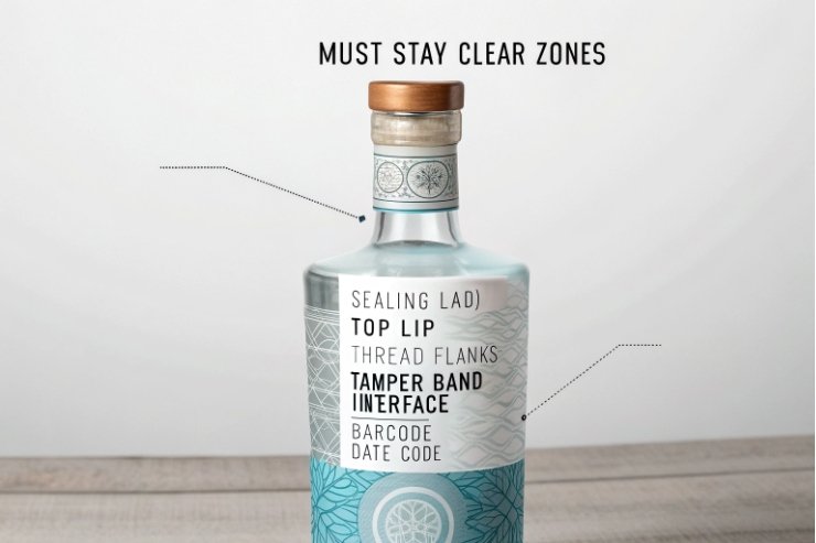 Spirits bottle showing must-stay-clear labeling zones and sealing land details