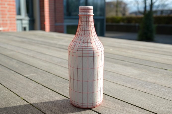 Glass bottle with red grid wrap indicating stress mapping and geometry measurement for design