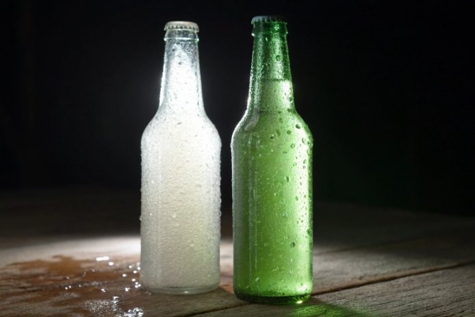 Condensation comparison on frosted clear bottle and green glass bottle
