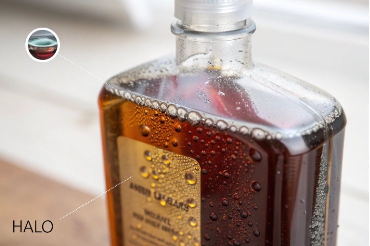 Square amber glass bottle with condensation droplets, showcasing premium packaging clarity