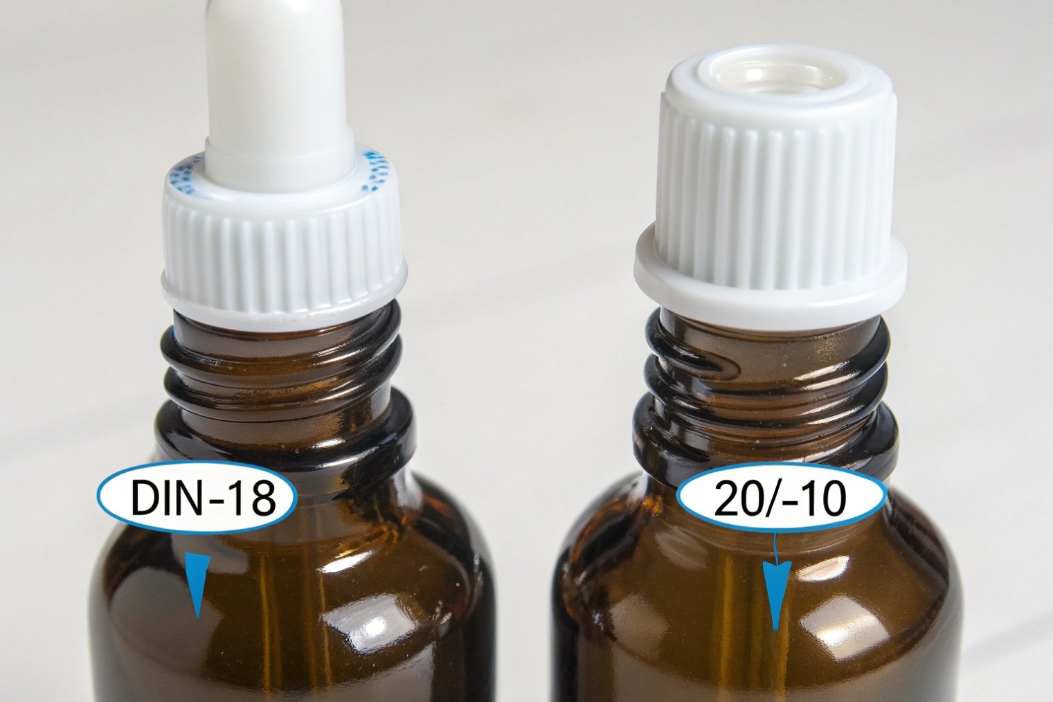 close up of amber dropper bottles with DIN18 and 20 10 neck finishes