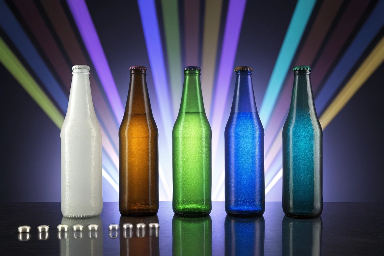 Colorful glass beer bottles with crowns displayed under decorative light beams