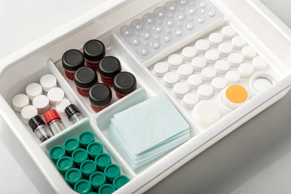 Organized tray of laboratory vials, caps, wipes and test components for packaging analysis