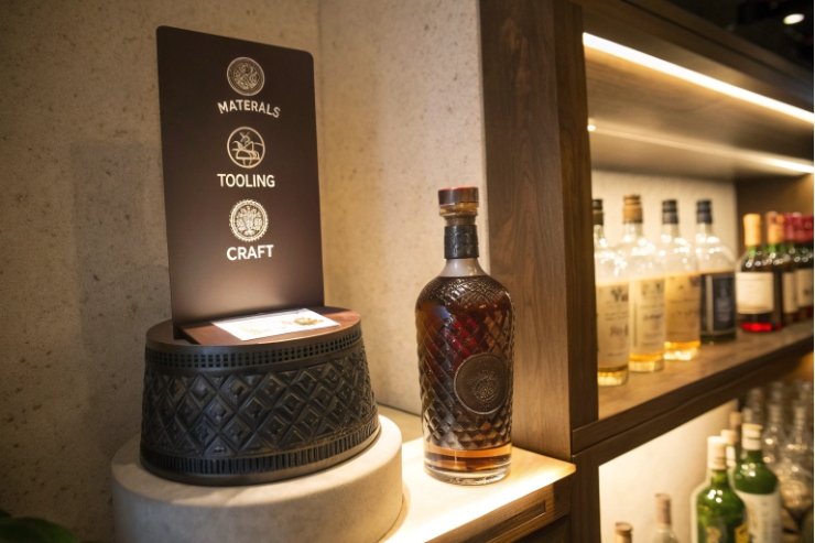 Showcase of engraved spirits decanter highlighting materials tooling and craft message