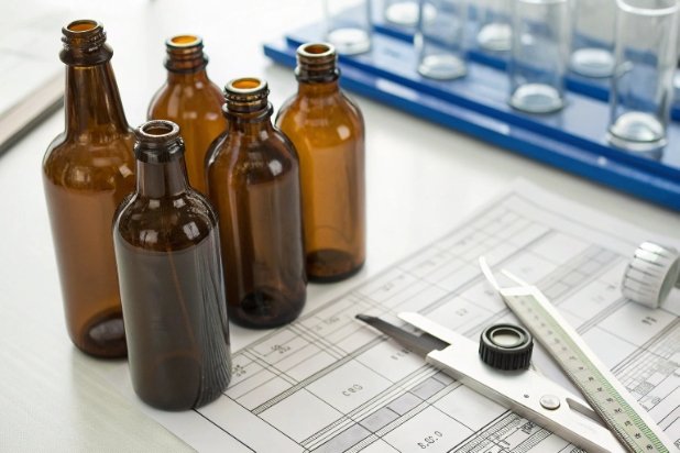 Amber Bottle QC Amber glass bottles with calipers and QC documents for dimensional inspection