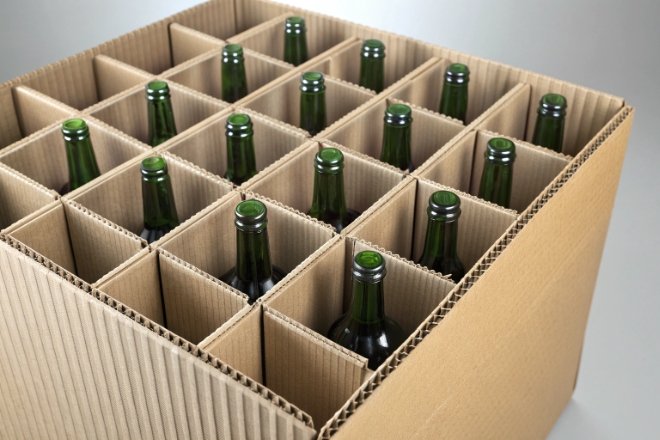 Green glass beer bottles packed in corrugated cardboard divider case for transport