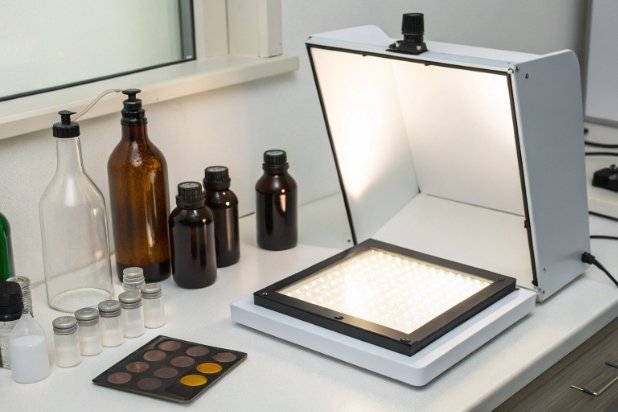 Laboratory workstation with amber bottles, vials, and inspection light box for QC