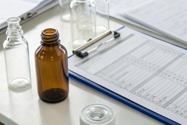 QC Sample Bottles Amber and clear sample bottles beside clipboard report for laboratory quality control