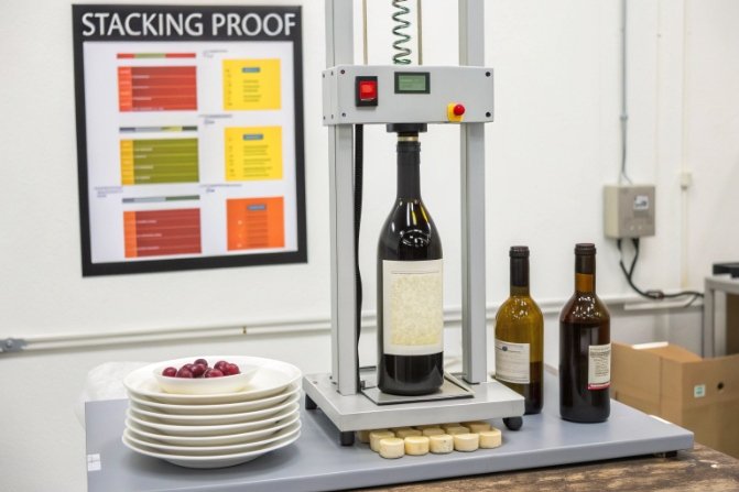 Stacking proof test machine measuring vertical load strength of a wine bottle.