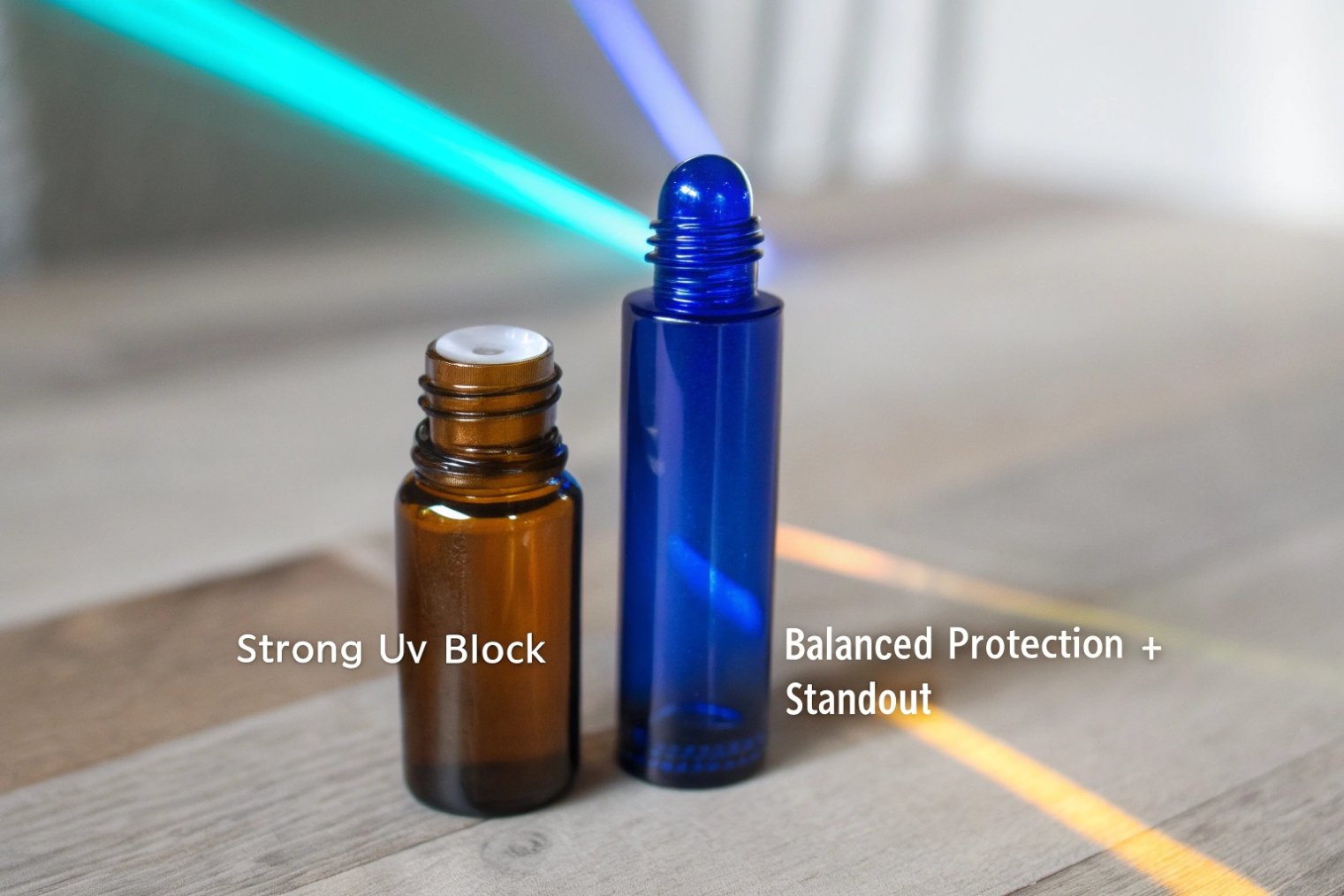 Amber and cobalt blue roller bottles comparing strong UV block and balanced protection.