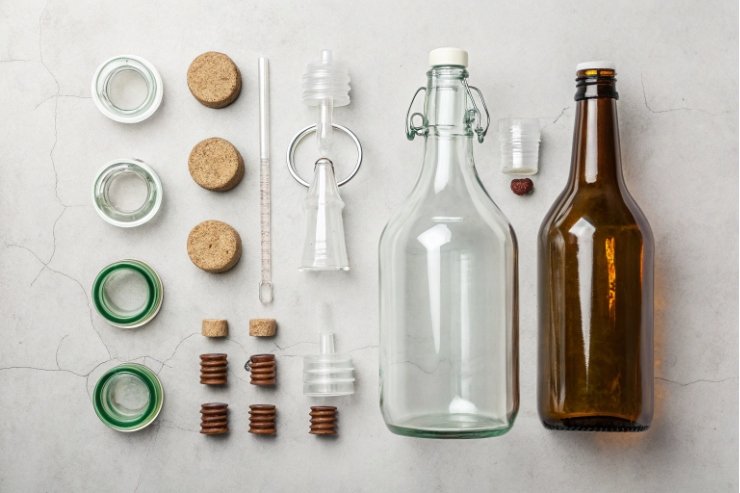 Flat lay of swing-top bottle, amber bottle, stoppers, gaskets and accessories