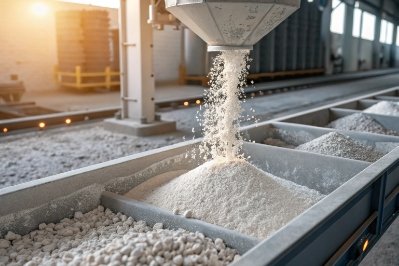 Glass batch raw materials pouring into sorting bins for industrial processing