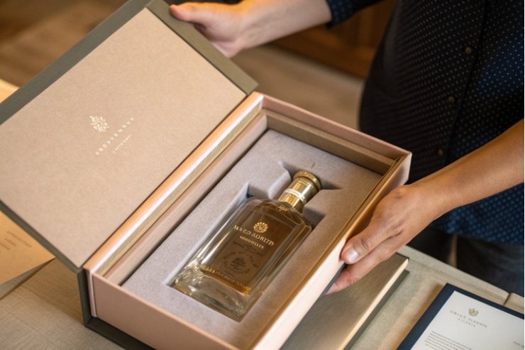 Luxury spirits bottle presented in custom rigid gift box with foam insert
