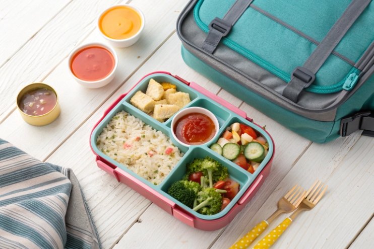 Colorful lunch bento box with compartments, backpack and dipping sauces