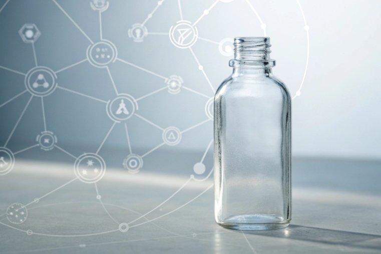 clear pharmaceutical glass bottle with scientific technology icons background
