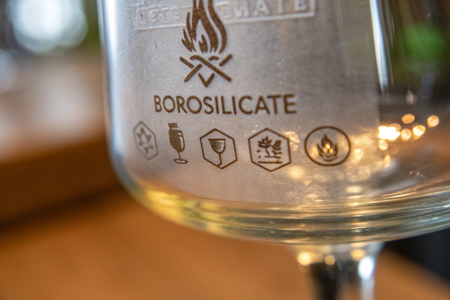 Close up borosilicate glass goblet with durability and heat resistant icons